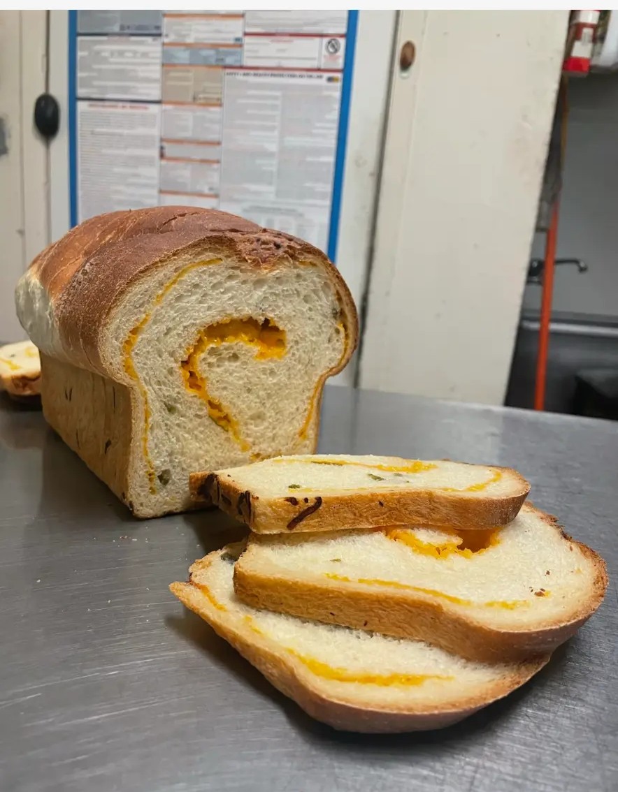 Our jalapeño cheddar loaf, sliced to show the cheddar swirl inside