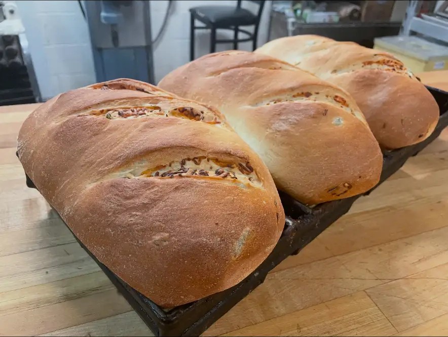 Freshly baked loaves with green chile and cheese, straight out of the oven in their baking tray